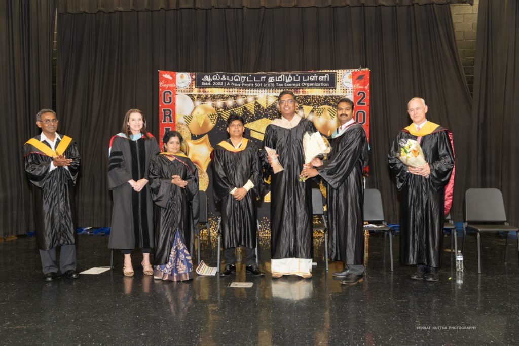 Faculty and graduates on stage at Graduation 2026